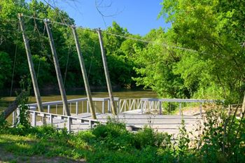 A wooden deck over a river in the woods